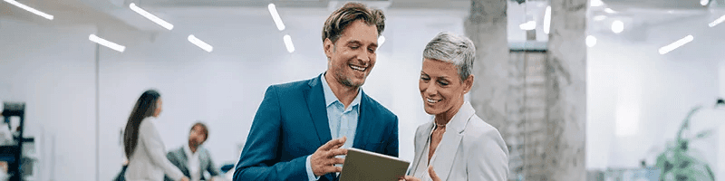 two people looking at a tablet