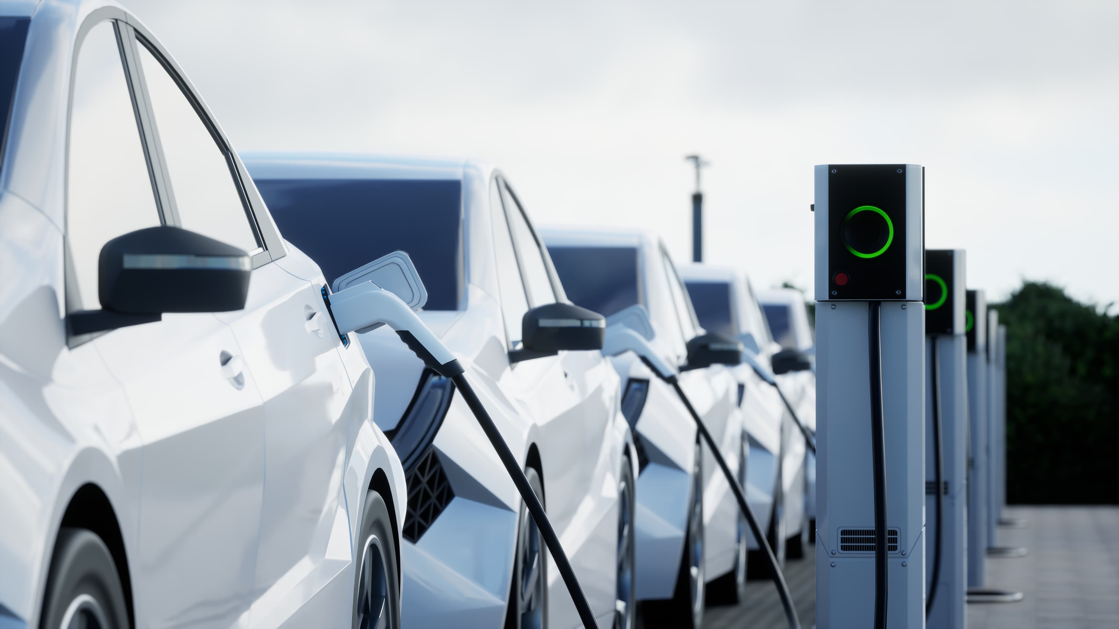 Woman inserts a power cord into an electric car